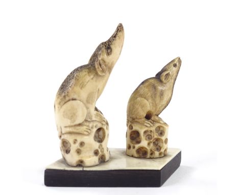 A pair of carved stag horn netsuke rats, on common hardwood and ivory base, height 7cm.Both carvings in good condition, screw