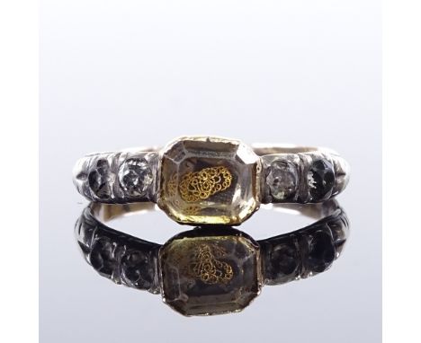 An 18th century unmarked gold Stuart Crystal mourning ring, gold thread monogram panel with silver-topped shoulders and close