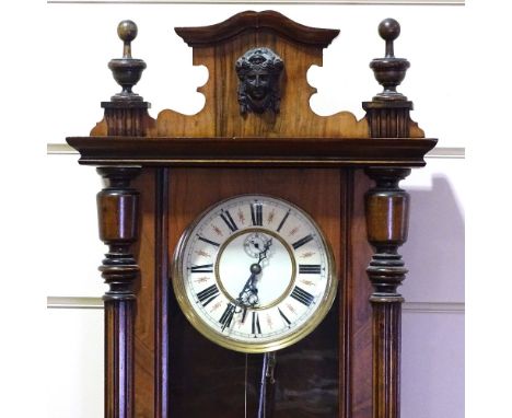 A 19th century walnut-cased Vienna regulator wall clock, with turned and fluted columns, enamel dial and 8-day movement, over