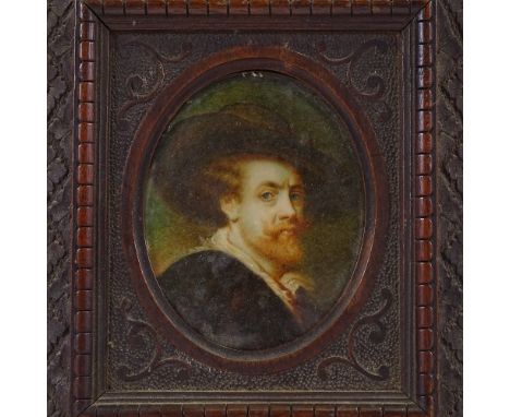 A 19th century miniature painted portrait on ivory, depicting a man wearing a wide brimmed hat, unsigned, in carved wood fram