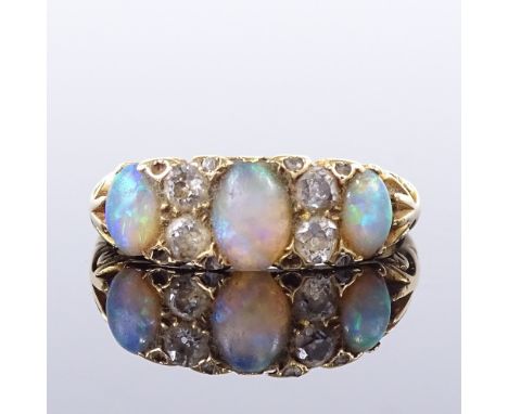 An early 20th century 18ct gold 7-stone opal and diamond half hoop ring, set with oval cabochon opals and old-cut diamonds wi