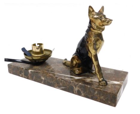 A mid century cold painted brass figural table lamp, modelled as a seated German Shepherd dog, raised on a brown marble base,