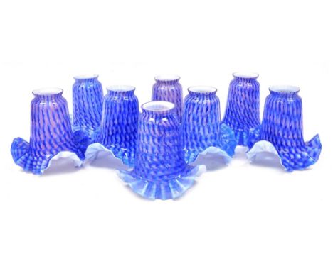 A group of moulded glass light shades, each in a pink and blue repeating pattern. (1 tray)