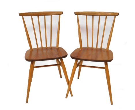A pair of Ercol light elm kitchen chairs, each with a slatted back, solid seat, and tapering cylindrical legs, 78cm high.