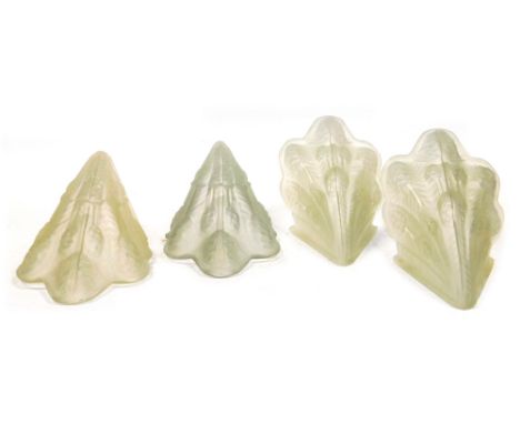 Four Art Deco moulded glass light shades, decorated with stylised flowers and leaves, 28cm high.