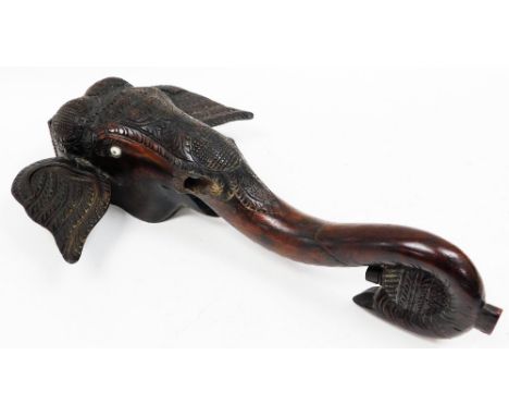 An early 20thC Indian carved hardwood figure of an elephant's head, with foliate carved jewelled head piece and ears, the tru