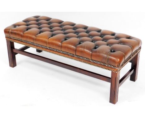 A Lexterton Limited mahogany framed duet stool, upholstered in button tan leather, raised on channelled square legs united by