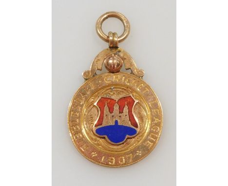 A 9ct gold and enamel cricketing medallion, for the Ribblesdale Cricket League 1907, with loop suspension, verso engraved Cli