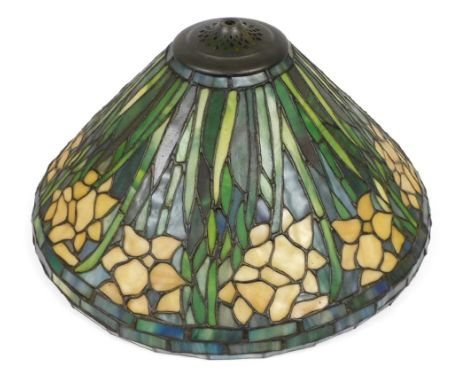 A Tiffany style lamp shade, decorated with repeating flowers and leaves, 43cm wide.