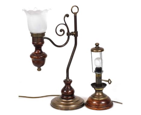 A copper and stained wooden table lamp, with a scrolling arm, holding a frilled glass shade, 47cm high, and a further table l