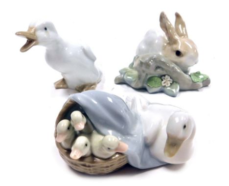 A Lladro porcelain figure of a rabbit beside a tree branch, printed marks, 10cm wide, together with a Lladro figure group of 