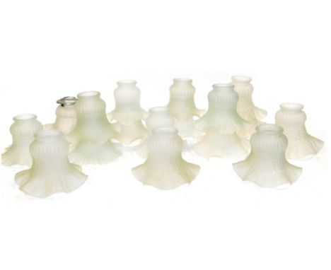 Seventeen frosted glass lamp shades, variously moulded, each 13cm wide. 
