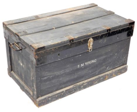 An early 20thC painted pine travelling trunk, with metal mounts with two rings and handles to each side, stamped to the front