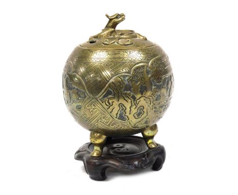 A Qing Dynasty bronze censer and cover, embossed with reserves of figures in a garden, the lid with a dragon finial, raised o