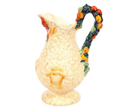 A Clarice Cliff Newport Pottery Harvest ware jug, of baluster form, moulded with fruit and bales of wheat, 23cm high.