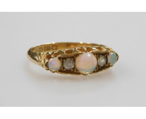 An 18ct gold opal and diamond five stone ring, in a claw setting, size O, 3.4g.