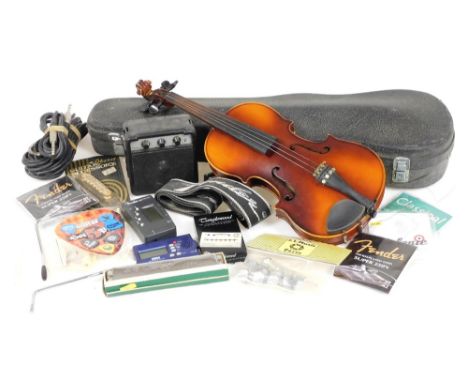 A Tatra Rosetti Stradivarius child's violin, with bow, cased, together with guitar accessories, an Encore guitar amplifier, e