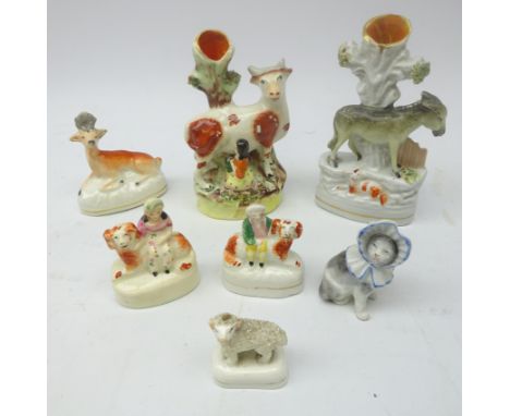 Victorian Staffordshire animals comprising Donkey spill vase, Cow with Milk Maid, Girl and Boy seated on Spaniels, Frit work 