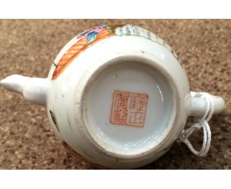 A Chinese Porcelain Miniature Teapot and Cover, Qianlong reign mark but probably not of the period, of ovoid form, painted in