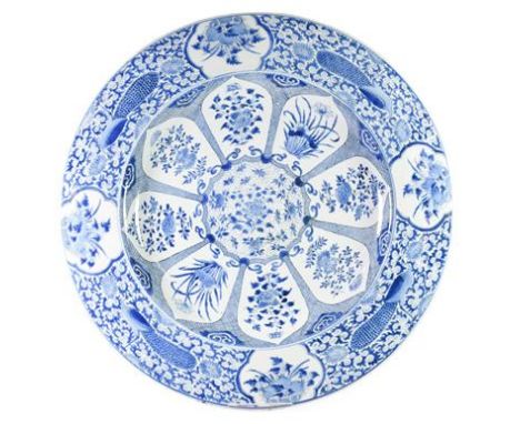 A Chinese Porcelain Large Circular Dish, Kangxi, painted in underglaze blue with a foliate roundel within radiating lappet sh