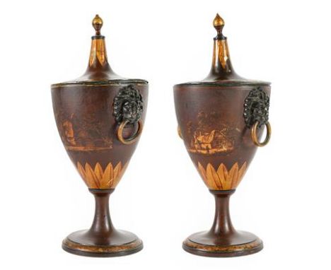 A Pair of Regency Toleware Chestnut Urns and Covers, with lion mask and ring handles on circular socles, gilt with landscapes