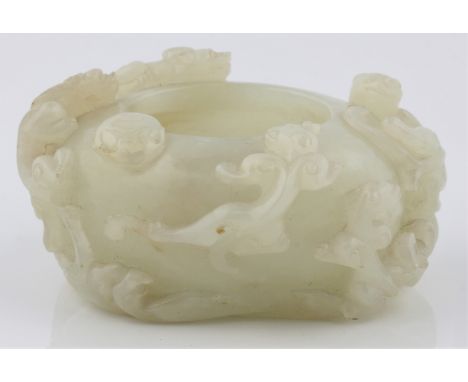 A pale green jade bowl with intricately carved dragon design, approx. 3cm x 7cm. IMPORTANT: Viewing is available for this lot