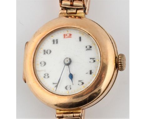 A hallmarked 9ct yellow gold ladies cocktail wrist watch, the white enamel dial having hourly Arabic numerals, on a mesh link