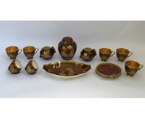 A Crown Devon part tea service with gold and burgundy oriental style design, including cups, saucers, jugs, bowls, dish and g