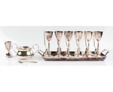 A collection of silver plated items, to include a pair of candelabras (A/F), a set of six egg cups with spoons and tray, a su