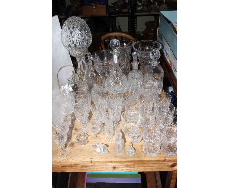 Good collection of crystal and other glass including lamp and shade, vases, decanters, jugs, glasses, two Swarovski swans, et