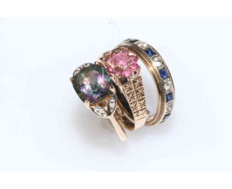 Collection of three 9 carat gold rings with ruby, sapphire and topaz.