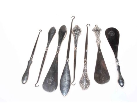 Three silver handled horns and five button hooks.