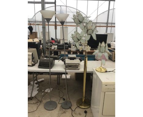 THREE STANDARD LAMPS TO INCLUDE TWO MODERN CHROME UPLIGHTERS AND A BRASS STYLE FLOWER DESIGN WITH MATCHING TABLE LAMP IN WORK