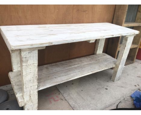 A WHITE COLOUR WASHED WOODEN TABLE WITH LOWER SHELF 