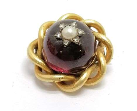 Antique unmarked yellow metal brooch (touch tests as 18ct gold) set with cabochon garnet with diamond &amp; pearl star detail