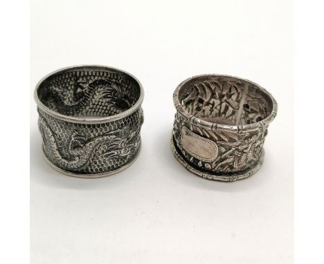 2 x unmarked Chinese silver napkin rings - 1 with double dragon detail &amp; the other with bamboo edge (a/f) - 45g 