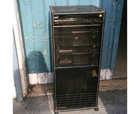 A Technics HiFi system with cabinet containing a quartz direct drive automatic turntable SL/QD33, a quartz synthesizer radio,