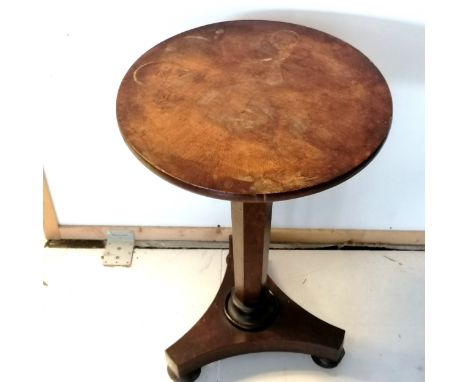 An Antique walnut pedestal, circular top occasional table on bun feet fitted with castors, the top having ring marks and age 