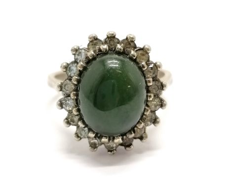 14ct marked white gold ring set with a green cabochon centre stone surrounded by white stone size K- 4.3g total weight 