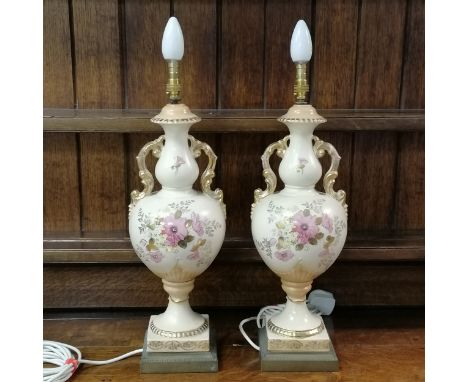 Pair of ceramic vase lamps, decorated with flowers on blush ivory background and gilded decoration on gilt metal bases, both 