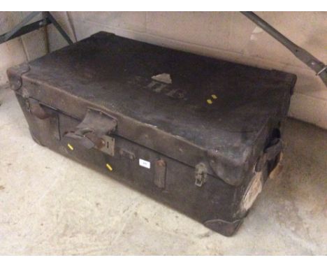 A large leather covered trunk and contents of various linen etc.