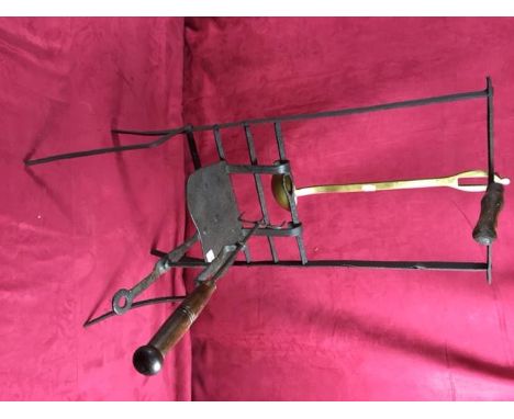 An 18th Century Downhearth wrought iron rack with adjustable lark spit and brass ladle