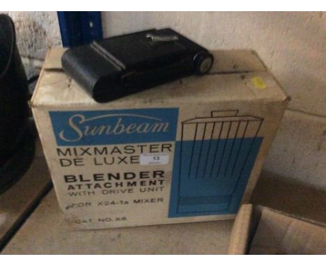 A Vintage folding camera and a Sunbearm blender attachment