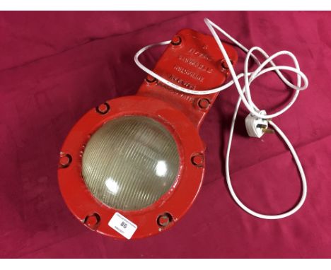 A red painted industrial Holophane lamp