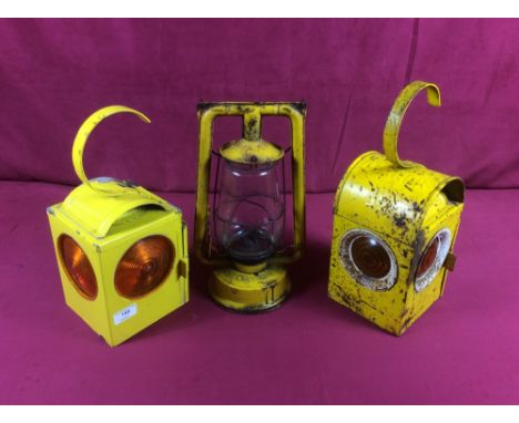 Two yellow road lamps and a Hurricane lamp