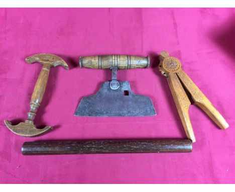 A box containing herb cutter, hat stretcher, map ruler and chip carved nut cracker