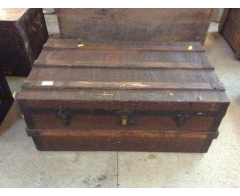 A vintage battened and crocodile skin effect travelling trunk