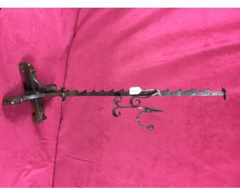 A floor standing "Sussex" type wrought iron rush light candle holder, on wooden base