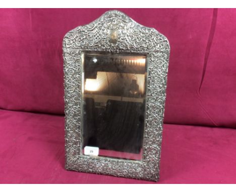 A large silver framed easel mirror