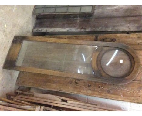 An Antique wooden and glazed arched window panel